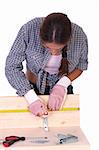 woman carpenter at work on white background
