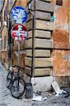 bycicle and signal in the ghetto neighbourhood in Roma. Wall is dirty and broken