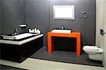 Contemporary black bathroom with orange wash basin