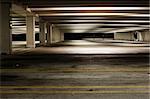 Empty parking garage at night, dirty and dark.