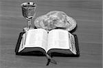 Bible, bread and chalice with wine