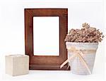 Wooden frame, candlestick and flower pot. Object over white