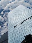 High modern skyscraper on a background of a blue sky and clouds.