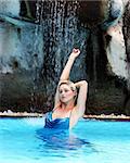 Attractive blond woman in the swimming pool.