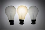 Three Light Bulbs on Grey Tone Background