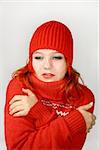 Young girl hides into the collar of the red sweater