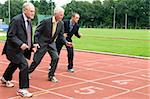 Group of businessmen are ready for the start of the run.