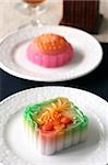 Colorful fruit flavored mooncakes with goldfish patterns signifying prosperity and wealth