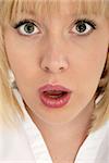 attractive blond girl with stunning eyes looking shocked or startled - close-up