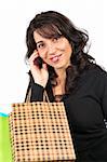 A woman holding several shopping bags and talking with phone, isolated on white background