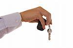 Detail of a hand holding a house key with a alarm remote control