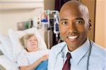 Doctor Smiling,Standing In Hospital Room