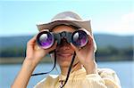 Business vision - woman with the binoculars over a mountains  and blue sky