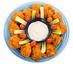 Delicious buffalo chicken wings with ranch dressing, celery, and grape tomatoes.  Isolated on white with clipping path