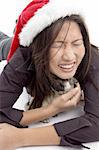 female with christmas hat and playing with pug with white background