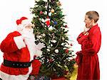 Little boy catches Santa in the act of bringing Christmas presents.  White background