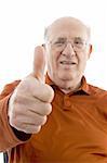 portrait of old man showing thumb up on an isolated background