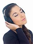 Beautiful young lady is liten to the music, eyes closed