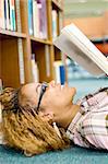 young african american student reading in library