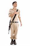 standing soldier with gun putting hand on his chest with white background
