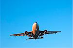 Wide body airliner approaching for landing in clear blue skies