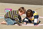 Kids Coloring with Chalk and Really Concentrating on their Work