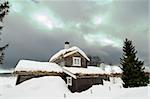 A winter cabin on a snowy landscape