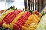 Platter of cut tropical fruits watermelon pineapple