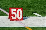 A red Football fifty yard marker