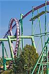 Rollercoaster tracks against a brilliant blue sky