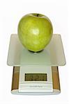 Big green apple on electronic kitchen scales