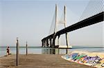 Lone runner near the Vasco da Gama Bridge, Portugal