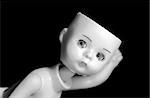 Close up of a doll with missing parts in black and white with high contrast