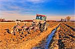 Tractor preparing the field before seeding