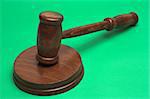 judge's gavel,close up over green background