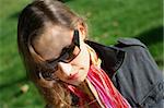 Fashionable business woman with dark glasses and colorful scarf.