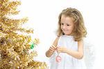 The girl - angel decorating a christmas tree