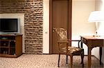 The TV and table with a lamp in modern hotel