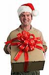 a delivery man in a santa hat delivering a gift with a bow - isolated