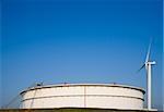 Oil storage and modern wind turbine in the Port of Rotterdam, Holland