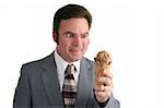 A businessman drooling and looking at a chocolate ice cream cone.