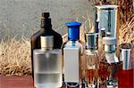 Assorted Fragrances bottles in an outdoor shot with dried grass background
