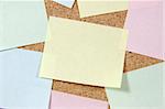 Close up of colorful post-it notes on corkboard