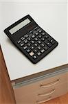 The calculator for accounting calculations on a table at office