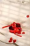 Box of chocolates with red ribbon on a bed for Valentin's day