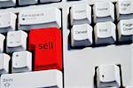 Computer Keyboard from a desktop computer with the enter key highlighted in Red with the word sell