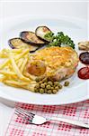 appetizing chicken fillet with green peas, fry potatoes and aubergine