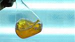 chemical flask wih yellow liquid