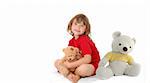 joyful young girl sitting on the floor with two teddy bears