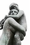 Child holding onto a sibling or a young mother at Vigeland Sculpture Park, Oslo Norway.  (Frognerparken)